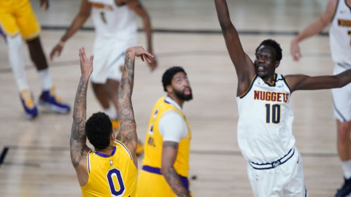 LAKE BUENA VISTA, FLORIDA - AUGUST 10: Kyle Kuzma #0 of the Los Angeles Lakers follows through on his game-winning three-pointer over Bol Bol #10 of the Denver Nuggets during the second half at The Arena at ESPN Wide World Of Sports Complex on August 10, 2020 in Lake Buena Vista, Florida. NOTE TO USER: User expressly acknowledges and agrees that, by downloading and or using this photograph, User is consenting to the terms and conditions of the Getty Images License Agreement. (Photo by Ashley Landis-Pool/Getty Images)