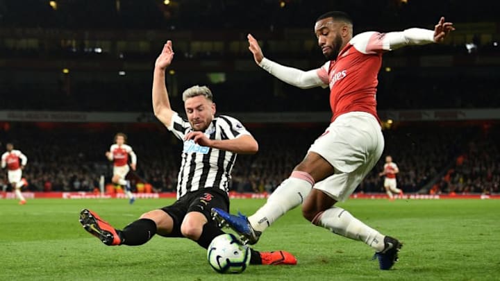 Newcastle United's Welsh defender Paul Dummett (L) blocks a cross from Arsenal's French striker Alexandre Lacazette during the English Premier League football match between Arsenal and Newcastle United at the Emirates Stadium in London on April 1, 2019. (Photo by Glyn KIRK / AFP) / RESTRICTED TO EDITORIAL USE. No use with unauthorized audio, video, data, fixture lists, club/league logos or 'live' services. Online in-match use limited to 120 images. An additional 40 images may be used in extra time. No video emulation. Social media in-match use limited to 120 images. An additional 40 images may be used in extra time. No use in betting publications, games or single club/league/player publications. / (Photo credit should read GLYN KIRK/AFP/Getty Images)