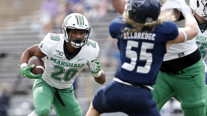 HOUSTON, TX – NOVEMBER 02: Brenden Knox #20 of the Marshall Thundering Herd runs the ball defended by Blaze Alldredge #55 of the Rice Owls in the first half on November 2, 2019 in Houston, Texas. (Photo by Tim Warner/Getty Images)