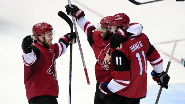 Feb 18, 2016; Glendale, AZ, USA; Arizona Coyotes center Martin Hanzal (11) celebrates with left wing Anthony Duclair (10) and center Max Domi (16) after scoring a goal in the third period against the Dallas Stars at Gila River Arena. Mandatory Credit: Matt Kartozian-USA TODAY Sports