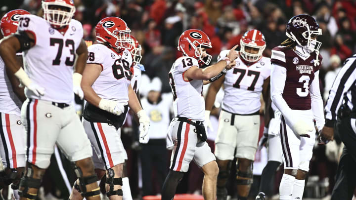 Nov 12, 2022; Starkville, Mississippi, USA;Georgia Bulldogs quarterback Stetson Bennett (13) reacts after a touchdown against the Mississippi State Bulldogs during the second quarter at Davis Wade Stadium at Scott Field. Mandatory Credit: Matt Bush-USA TODAY Sports