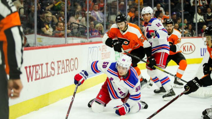 PHILADELPHIA, PA - SEPTEMBER 21: New York Rangers center Lias Andersson (50) dives to keep control of the puck behind the Philadelphia Flyers net during the NHL Preseason game between the New York Rangers and Philadelphia Flyers on September 21, 2019, at Wells Fargo Center in Philadelphia, PA. (Photo by Nicole Fridling/Icon Sportswire via Getty Images)