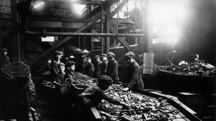 Young boys working the troughs in the mines of South Wales, circa 1910.