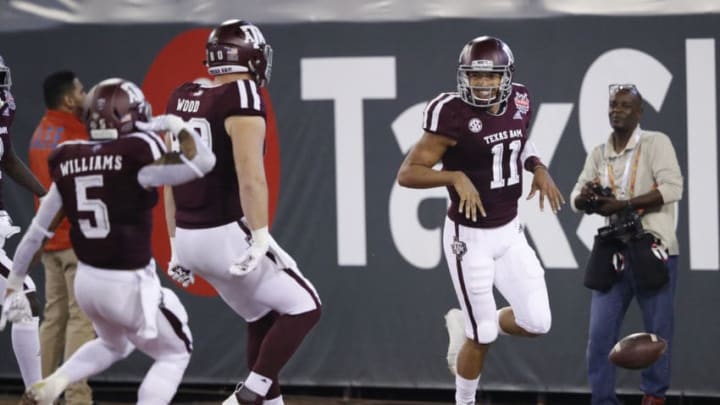 JACKSONVILLE, FL - DECEMBER 31: Kellen Mond #11 of the Texas A&M Aggies reacts after rushing for a 62-yard touchdown on the second play of the game against the North Carolina State Wolfpack in the first half of the TaxSlayer Gator Bowl at TIAA Bank Field on December 31, 2018 in Jacksonville, Florida. (Photo by Joe Robbins/Getty Images)