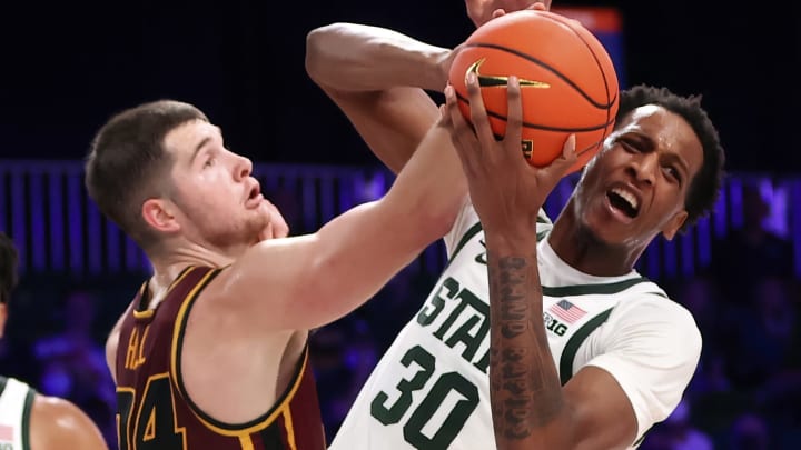 Nov 24, 2021; Nassau, BHS; Michigan State Spartans forward Marcus Bingham Jr. (30) and Loyola Ramblers guard Tate Hall (24) go for the ball during the second half of the 2021 Battle 4 Atlantis Tournament at Imperial Arena. Mandatory Credit: Kevin Jairaj-USA TODAY Sports