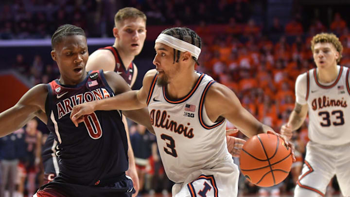 Dec 11, 2021; Champaign, Illinois, USA; Illinois Fighting Illini guard Jacob Grandison (3) drives to the basket against Arizona Wildcats guard Benedict Mathurin (0) during the second half at State Farm Center. Mandatory Credit: Ron Johnson-USA TODAY Sports