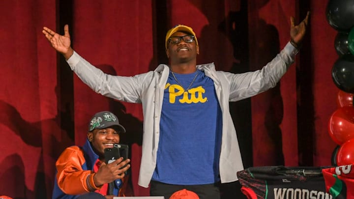 WASHINGTON, MD - FEBRUARY 7: Noah Boykin (L), who committed to Notre Dame, records his teammate Mychale Salahudin as he shows off his t-shirt indicating his choice to play at Pitt during a National Signing day event at H.D. Woodson High School. (Photo by Jonathan Newton/The Washington Post via Getty Images)