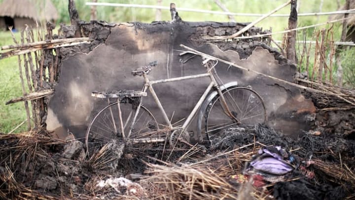 A burned house and bicycle in South Sudan.