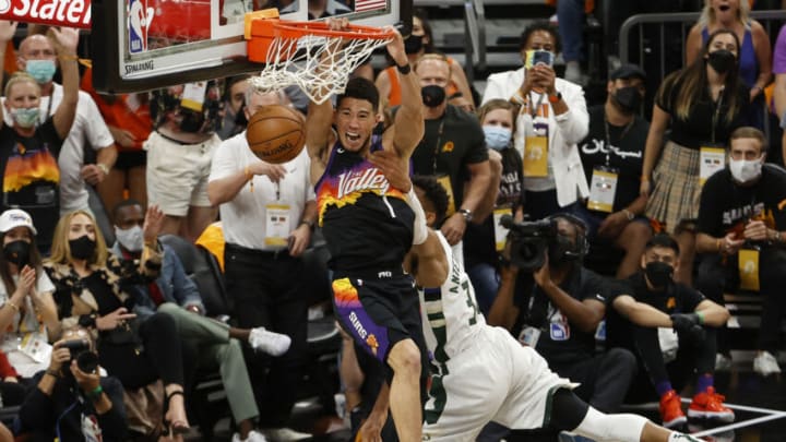 PHOENIX, ARIZONA - JULY 17: Giannis Antetokounmpo #34 of the Milwaukee Bucks fouls Devin Booker #1 of the Phoenix Suns during the first half in Game Five of the NBA Finals at Footprint Center on July 17, 2021 in Phoenix, Arizona. NOTE TO USER: User expressly acknowledges and agrees that, by downloading and or using this photograph, User is consenting to the terms and conditions of the Getty Images License Agreement. (Photo by Christian Petersen/Getty Images)