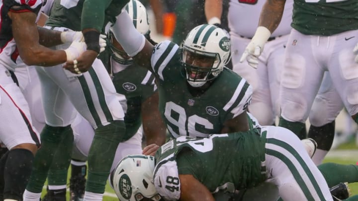 EAST RUTHERFORD, NJ - OCTOBER 29: Outside linebacker Jordan Jenkins #48 of the New York Jets recovers the ball as teammate defensive end Muhammad Wilkerson #96 reacts against the Atlanta Falcons during the first quarter of the game at MetLife Stadium on October 29, 2017 in East Rutherford, New Jersey. (Photo by Ed Mulholland/Getty Images)