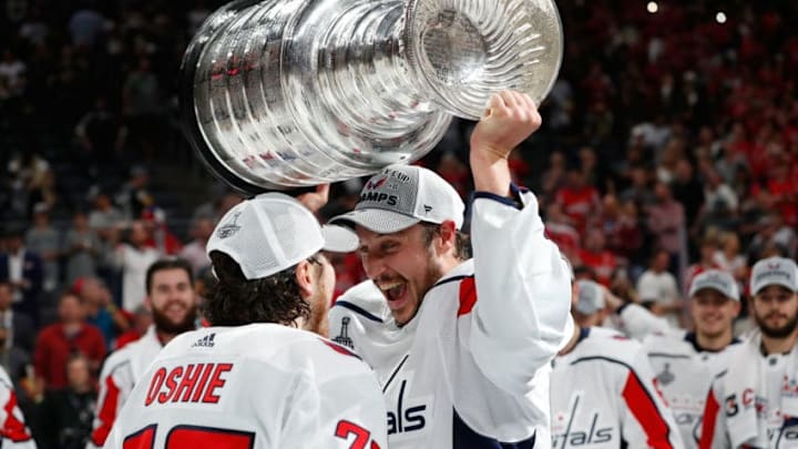 LAS VEGAS, NV - JUNE 07: Jay Beagle #83 of the Washington Capitals takes the Stanley Cup from teammate T.J. Oshie #77 as they celebrate after Game Five of the 2018 NHL Stanley Cup Final between the Washington Capitals and the Vegas Golden Knights at T-Mobile Arena on June 7, 2018 in Las Vegas, Nevada. The Capitals defeated the Golden Knights 4-3 to win the Stanley Cup Final Series 4-1. (Photo by Patrick McDermott/NHLI via Getty Images)