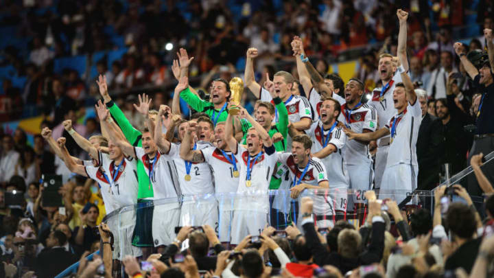 RIO DE JANEIRO, BRAZIL - JULY 13: Philipp Lahm of Germany lifts the World Cup trophy with teammates after defeating Argentina 1-0 in extra time during the 2014 FIFA World Cup Brazil Final match between Germany and Argentina at Maracana on July 13, 2014 in Rio de Janeiro, Brazil. (Photo by Matthias Hangst/Getty Images)