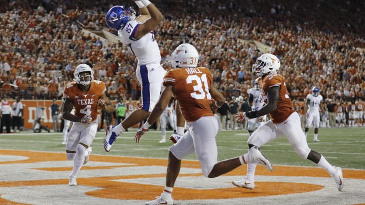 AUSTIN, TX – NOVEMBER 11: Kashe Boatner #87 of the Kansas Jayhawks catches a pass for a touchdown in the second quarter defended by Jason Hall #31 of the Texas Longhorns, DeShon Elliott #4, and Gary Johnson #33 at Darrell K Royal-Texas Memorial Stadium on November 11, 2017 in Austin, Texas. (Photo by Tim Warner/Getty Images)