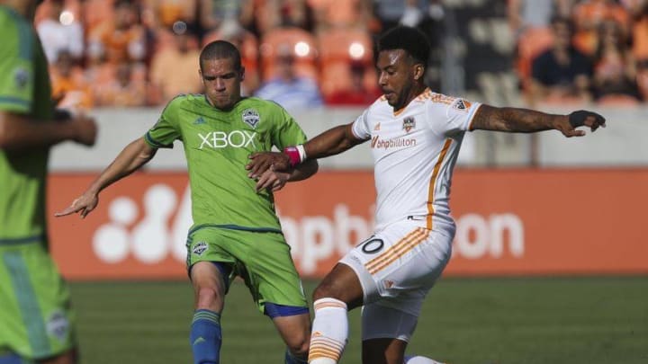 Oct 18, 2015; Houston, TX, USA; Seattle Sounders FC midfielder Osvaldo Alonso (6) and Houston Dynamo forward Giles Barnes (10) battle for the ball during the first half at BBVA Compass Stadium. Mandatory Credit: Troy Taormina-USA TODAY Sports