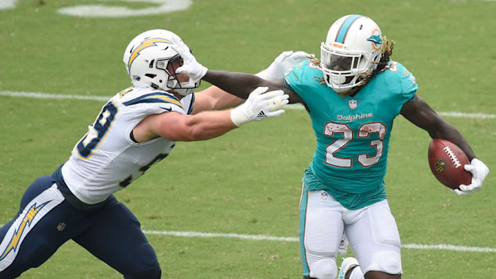CARSON, CA - SEPTEMBER 17: Jay Ajayi #23 of the Miami Dolphins eludes Joey Bosa #99 of the Los Angeles Chargers as he rushes to gain during the game at the StubHub Center on September 17, 2017 in Carson, California. (Photo by Kevork Djansezian/Getty Images)