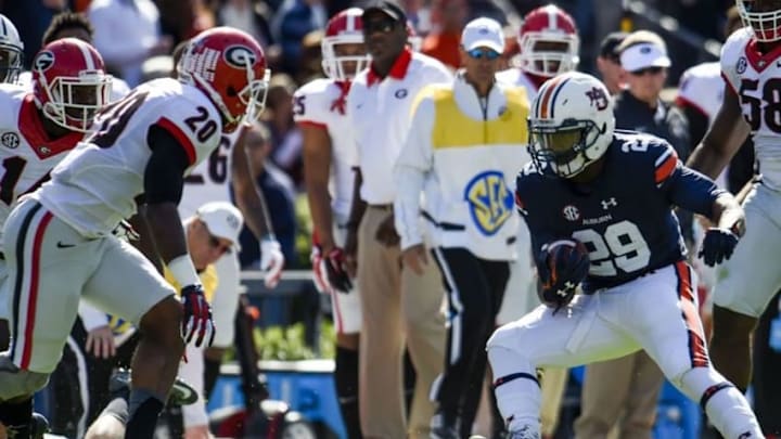 Nov 14, 2015; Auburn, AL, USA; Auburn Tigers running back Jovon Robinson (29) runs the ball while defended by Georgia Bulldogs safety Quincy Mauger (20) during the first quarter at Jordan Hare Stadium. Mandatory Credit: Shanna Lockwood-USA TODAY Sports