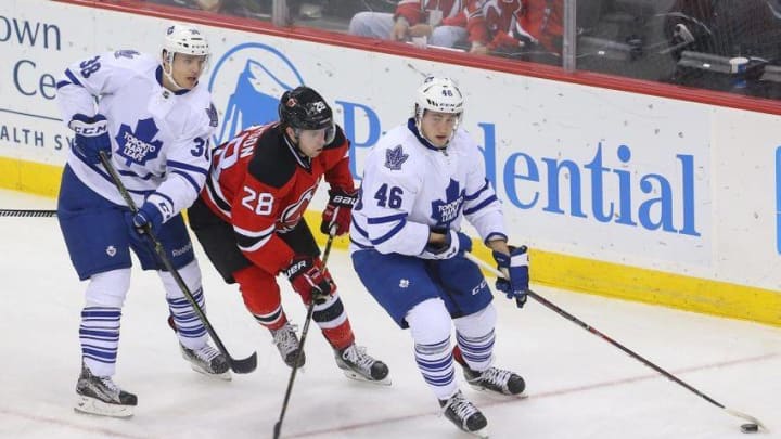 Apr 9, 2016; Newark, NJ, USA; Toronto Maple Leafs right wing Tobias Lindberg (46) skates with the puck while being defended by New Jersey Devils defenseman Damon Severson (28) during the third period at Prudential Center. The Devils defeated the Maple Leafs 5-1. Mandatory Credit: Ed Mulholland-USA TODAY Sports