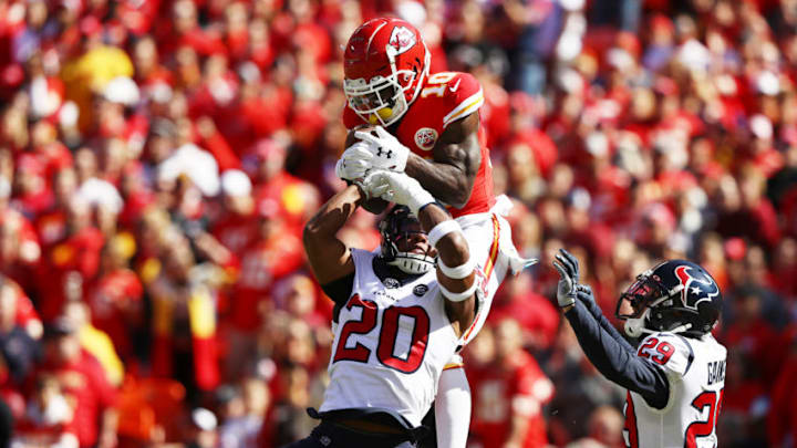 KANSAS CITY, MISSOURI - OCTOBER 13: Tyreek Hill #10 of the Kansas City Chiefs makes a 46-yard touchdown reception against Justin Reid #20 and Phillip Gaines #29 of the Houston Texans during the first quarter at Arrowhead Stadium on October 13, 2019 in Kansas City, Missouri. (Photo by Jamie Squire/Getty Images)