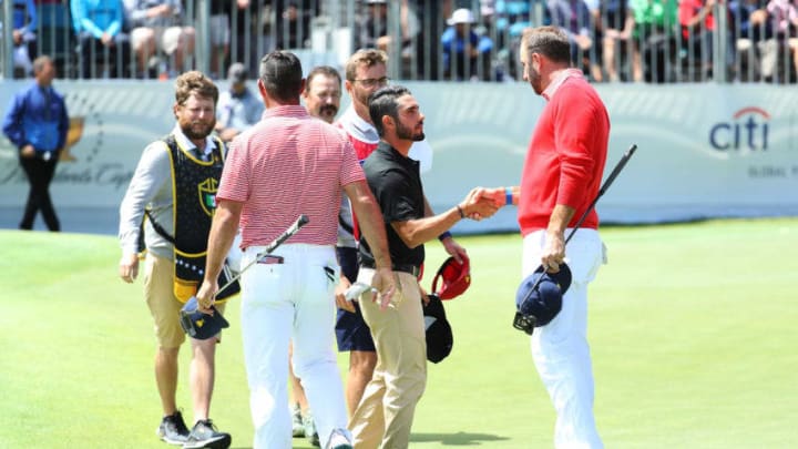 MELBOURNE, AUSTRALIA - DECEMBER 12: Abraham Ancer of Mexico and the International team and Louis Oosthuizen (not pictured) of South Africa and the International team shake hands with Gary Woodland of the United States team and Dustin Johnson of the United States team after defeating them 4&3 on the 15th green during Thursday four-ball matches on day one of the 2019 Presidents Cup at Royal Melbourne Golf Course on December 12, 2019 in Melbourne, Australia. (Photo by Warren Little/Getty Images)