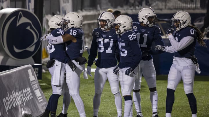STATE COLLEGE, PA - DECEMBER 19: Lamont Wade #38 of the Penn State Nittany Lions celebrates with teammates after returning a kick 100 yards for a touchdown against the Illinois Fighting Illini during the first half at Beaver Stadium on December 19, 2020 in State College, Pennsylvania. (Photo by Scott Taetsch/Getty Images)