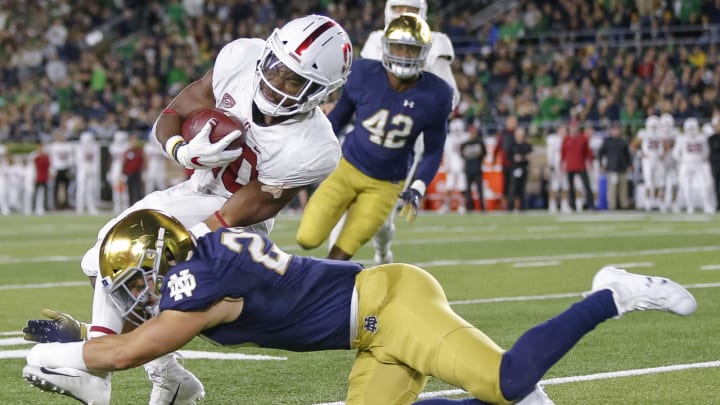 SOUTH BEND, IN – SEPTEMBER 29: Bryce Love #20 of the Stanford Cardina runs the ball and is tackled by Drue Tranquill #23 of the Notre Dame Fighting Irish during the first half of the game at Notre Dame Stadium on September 29, 2018 in South Bend, Indiana. (Photo by Michael Hickey/Getty Images)