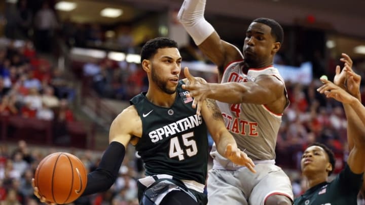 Feb 23, 2016; Columbus, OH, USA; Michigan State Spartans guard Denzel Valentine (45) speeds past Ohio State Buckeyes center Daniel Giddens (4) during the second half at Value City Arena. The Spartans won 81-62. Mandatory Credit: Joe Maiorana-USA TODAY Sports