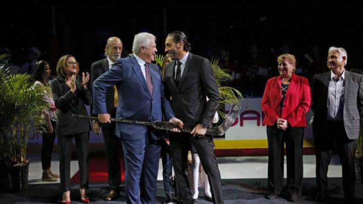 SUNRISE, FL - OCTOBER 13: Goaltender Roberto Luongo is presented with a gold and crystal stick by President of Hockey Operations and General Manager Dale Tallon during a celebration of playing in 1000th NHL game. Prior to the Florida Panthers hosting the Vancouver Canucks at the BB&T Center on October 13, 2018 in Sunrise, Florida. (Photo by Eliot J. Schechter/NHLI via Getty Images)