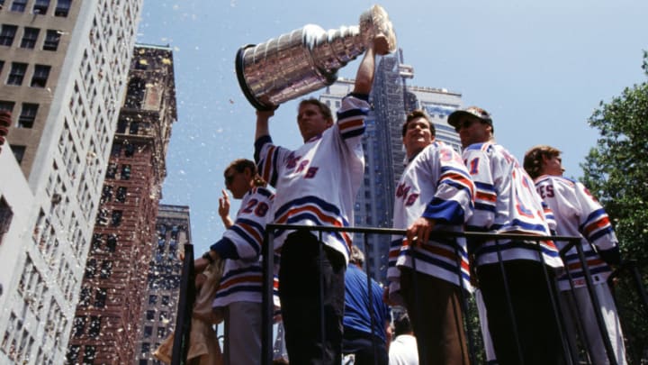 NEW YORK, NY - JUNE 17: Brian Leetch #2 of the New York Rangers holds the Stanley Cup Trophy as his teammates Mark Messier #11 and goalie Mike Richter #35 ride along with him during the New York Rangers Stanley Cup Ticker-Tape Parade on June 17, 1994 after they defeated the Vancouver Canucks in New York, New York. (Photo by Bruce Bennett Studios via Getty Images Studios/Getty Images)