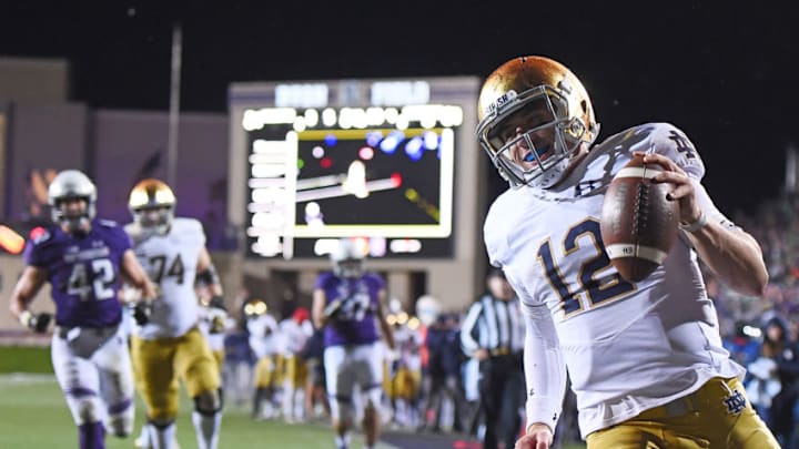 EVANSTON, IL - NOVEMBER 03: Ian Book #12 of the Notre Dame Fighting Irish rushes for a touchdown during the second half of a game against the Northwestern Wildcats at Ryan Field on November 3, 2018 in Evanston, Illinois. (Photo by Stacy Revere/Getty Images)