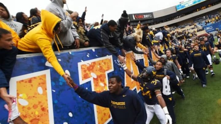 Oct 18, 2014; Morgantown, WV, USA; West Virginia Mountaineers celebrate with the fan after the game against Baylor Bears at Milan Puskar Stadium. West Virginia Mountaineers defeated Baylor Bears 41-27. Mandatory Credit: Tommy Gilligan-USA TODAY Sports