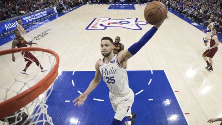 PHILADELPHIA, PA - APRIL 6: Ben Simmons #25 of the Philadelphia 76ers dunks the ball past LeBron James #23 of the Cleveland Cavaliers in the second quarter at the Wells Fargo Center on April 6, 2018 in Philadelphia, Pennsylvania. The 76ers defeated the Cavaliers 132-130. (Photo by Mitchell Leff/Getty Images)
