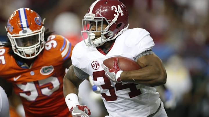 Dec 3, 2016; Atlanta, GA, USA; Alabama Crimson Tide running back Damien Harris (34) runs the ball against Florida Gators defensive lineman Keivonnis Davis (95) during the third quarter of the SEC Championship college football game at Georgia Dome. Mandatory Credit: Brett Davis-USA TODAY Sports