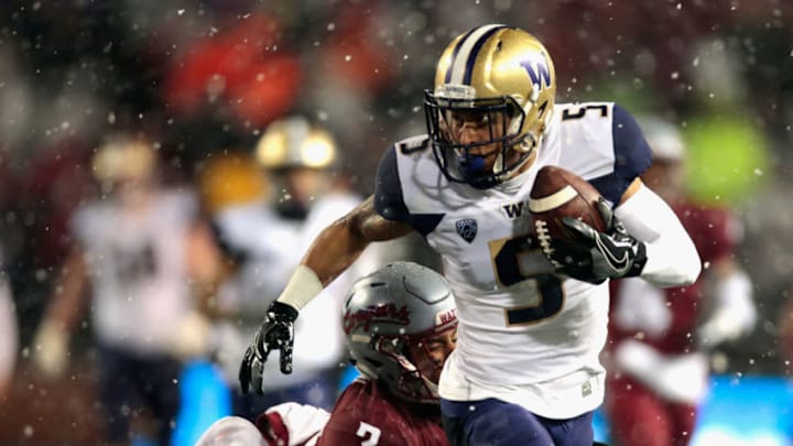 PULLMAN, WA - NOVEMBER 23: Andre Baccellia #5 of the Washington Huskies carries the ball against Darrien Molton #3 of the Washington State Cougars in the first half at Martin Stadium during the 111th Apple Cup on November 23, 2018 in Pullman, Washington. (Photo by William Mancebo/Getty Images)