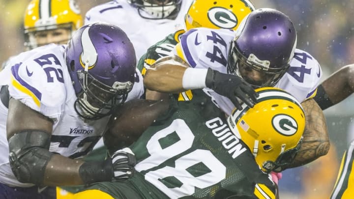 Oct 2, 2014; Green Bay, WI, USA; Green Bay Packers defensive tackle Letroy Guion (98) tackles Minnesota Vikings running back Matt Asiata (44) during the first quarter at Lambeau Field. Mandatory Credit: Jeff Hanisch-USA TODAY Sports