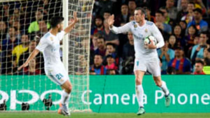 Real Madrid’s Welsh forward Gareth Bale (R) celebrates with Real Madrid’s Spanish midfielder Marco Asensio after scoring a goal during the Spanish league football match between FC Barcelona and Real Madrid CF at the Camp Nou stadium in Barcelona on May 6, 2018. (Photo by LLUIS GENE / AFP) (Photo credit should read LLUIS GENE/AFP/Getty Images)