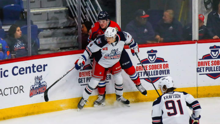 HARTFORD, CT - OCTOBER 18: Hartford Wolfpack defenseman Joey Keane (4) pins Springfield Thunderbirds forward Owen Tippett (74) against the boards as Hartford Wolfpack left wing Vitali Kravtsov (91) closes in to clear puck during the Springfield Thunderbirds and Hartford Wolfpack AHL game on October 18, 2019, at XL Center in Hartford, CT. (Photo by John Crouch/Icon Sportswire via Getty Images)