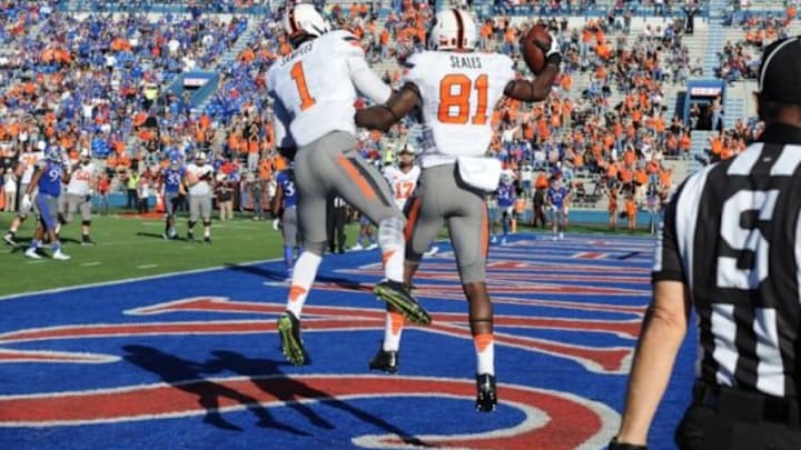 Oct 11, 2014; Lawrence, KS, USA; Oklahoma State Cowboys wide receiver Jhajuan Seales (81) celebrates with wide receiver Ra