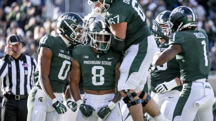 EAST LANSING, MICHIGAN - OCTOBER 15: Keon Coleman #0, Jalen Berger #8 and J.D. Duplain #67 of the Michigan State Spartans celebrate Berger's touchdown against the Wisconsin Badgers during the first quarter at Spartan Stadium on October 15, 2022 in East Lansing, Michigan. (Photo by Nic Antaya/Getty Images)