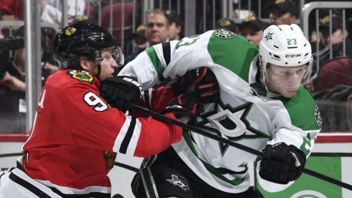 CHICAGO, IL - FEBRUARY 24: Drake Caggiula #91 of the Chicago Blackhawks pushes into Esa Lindell #23 of the Dallas Stars in the third period at the United Center on February 24, 2019 in Chicago, Illinois. (Photo by Bill Smith/NHLI via Getty Images)