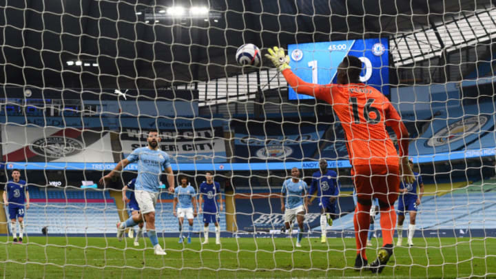 MANCHESTER, ENGLAND - MAY 08: Edouard Mendy of Chelsea saves a penalty taken by Sergio Aguero of Manchester City during the Premier League match between Manchester City and Chelsea at Etihad Stadium on May 08, 2021 in Manchester, England. Sporting stadiums around the UK remain under strict restrictions due to the Coronavirus Pandemic as Government social distancing laws prohibit fans inside venues resulting in games being played behind closed doors. (Photo by Shaun Botterill/Getty Images)