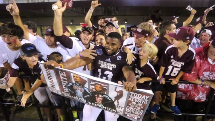 Oct 11, 2014; Starkville, MS, USA; Mississippi State Bulldogs running back Josh Robinson (13) celebrates with the Mississippi State Bulldogs fans after the game at Davis Wade Stadium. Mississippi State Bulldogs defeated the Auburn Tigers 38-23. Mandatory Credit: Spruce Derden-USA TODAY Sports