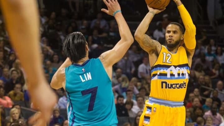 Mar 19, 2016; Charlotte, NC, USA; Denver Nuggets guard D.J. Augustin (12) shoots the ball against Charlotte Hornets guard Jeremy Lin (7) during the second half at Time Warner Cable Arena. The Nuggets defeated the Hornets 101-93. Mandatory Credit: Jeremy Brevard-USA TODAY Sports