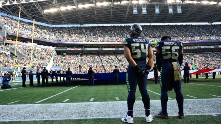 Nov 21, 2021; Seattle, Washington, USA; Seattle Seahawks middle linebacker Bobby Wagner (54) and Seattle Seahawks outside linebacker Jordyn Brooks (56) during the National Anthem prior to the game against the Arizona Cardinals. Arizona defeated Seattle 23-13. Mandatory Credit: Steven Bisig-USA TODAY Sports
