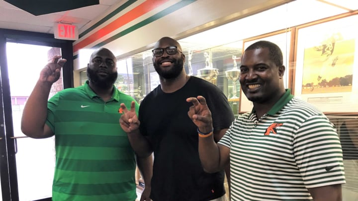 Right tackle Calvin Johnson posed in front of some of the hardware inside the Galimore-Powell Field House at FAMU on Wednesday, Aug. 14, 2019. He shared this moment with offensive line coach Alex Jackson (left) and head coach Willie