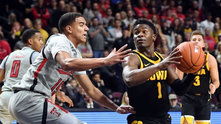 Joe Toussaint #1 of the Iowa Hawkeyes drives to the basket against Kevin McCullar #15 of the Texas Tech Red Raiders  (Photo by Ethan Miller/Getty Images)