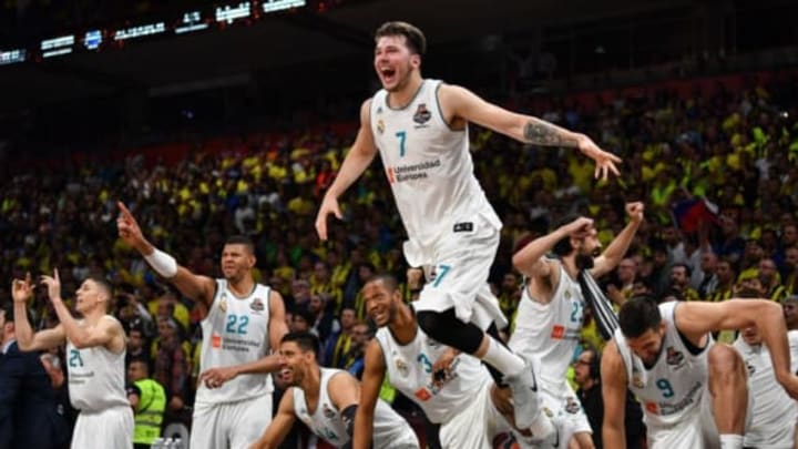 Real Madrid’s Slovenian Luka Doncic (C) jumps over the barrier as the team celebrates their 85-80 win in the Euroleague Final Four finals basketball match between Real Madrid and Fenerbahce Dogus Istanbul at The Stark Arena in Belgrade on May 20, 2018. (Photo by Andrej ISAKOVIC / AFP) (Photo credit should read ANDREJ ISAKOVIC/AFP/Getty Images)