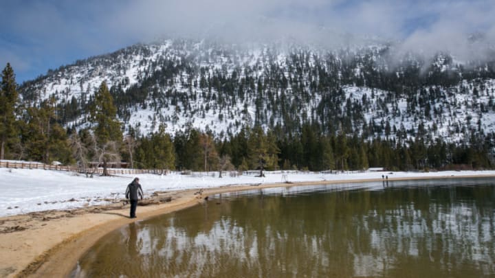SAND HARBOR, NV - JANUARY 31: Visitors to Lake Tahoe walk along the snow-free shoreline on January 31, 2017, in Sand Harbor, Nevada. The six-year drought in California and Nevada has been called off by the Federal government following record rain throughout the states and up to 25 feet of snow in the Sierra Nevada Mountain Range. (Photo by George Rose/Getty Images)