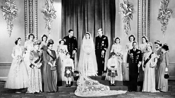 Members of the British Royal family and guests pose around Princess Elizabeth (future Queen Elizabeth II) and Philip, Duke of Edinburgh.