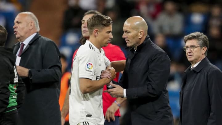 MADRID, SPAIN - MARCH 31: (L-R) Marcos Llorente of Real Madrid, coach Zinedine Zidane of Real Madrid during the La Liga Santander match between Real Madrid v SD Huesca at the Santiago Bernabeu on March 31, 2019 in Madrid Spain (Photo by David S. Bustamante/Soccrates/Getty Images)