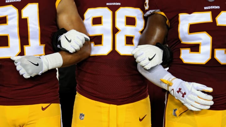 LANDOVER, MD - SEPTEMBER 24: Defensive tackle Matthew Ioannidis #98 of the Washington Redskins locks arms with teammates in unison during the national anthem before playing against the Oakland Raiders at FedExField on September 24, 2017 in Landover, Maryland. (Photo by Patrick Smith/Getty Images)